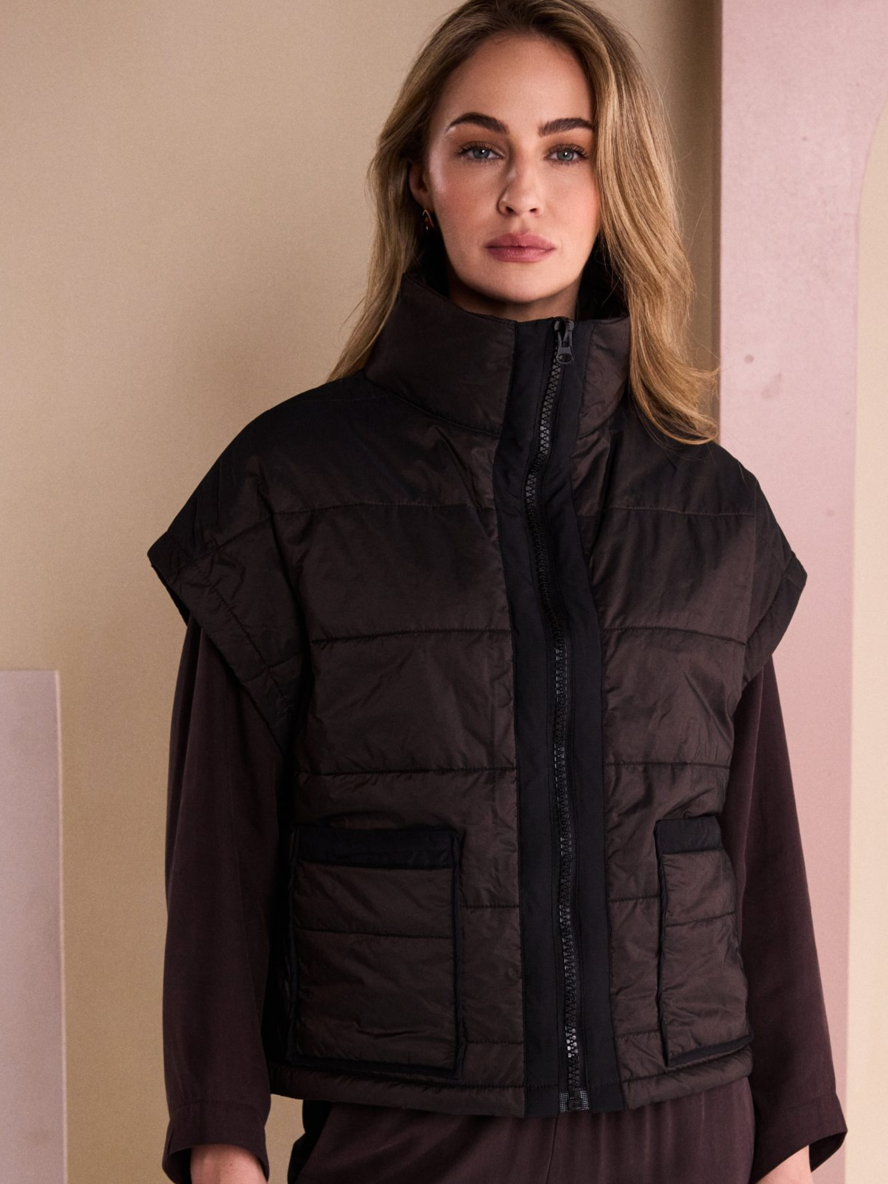 Naya NAW26 167 Padded Short Waistcoat with high neckline, zip front, patch pockets and sleeveless padded finish