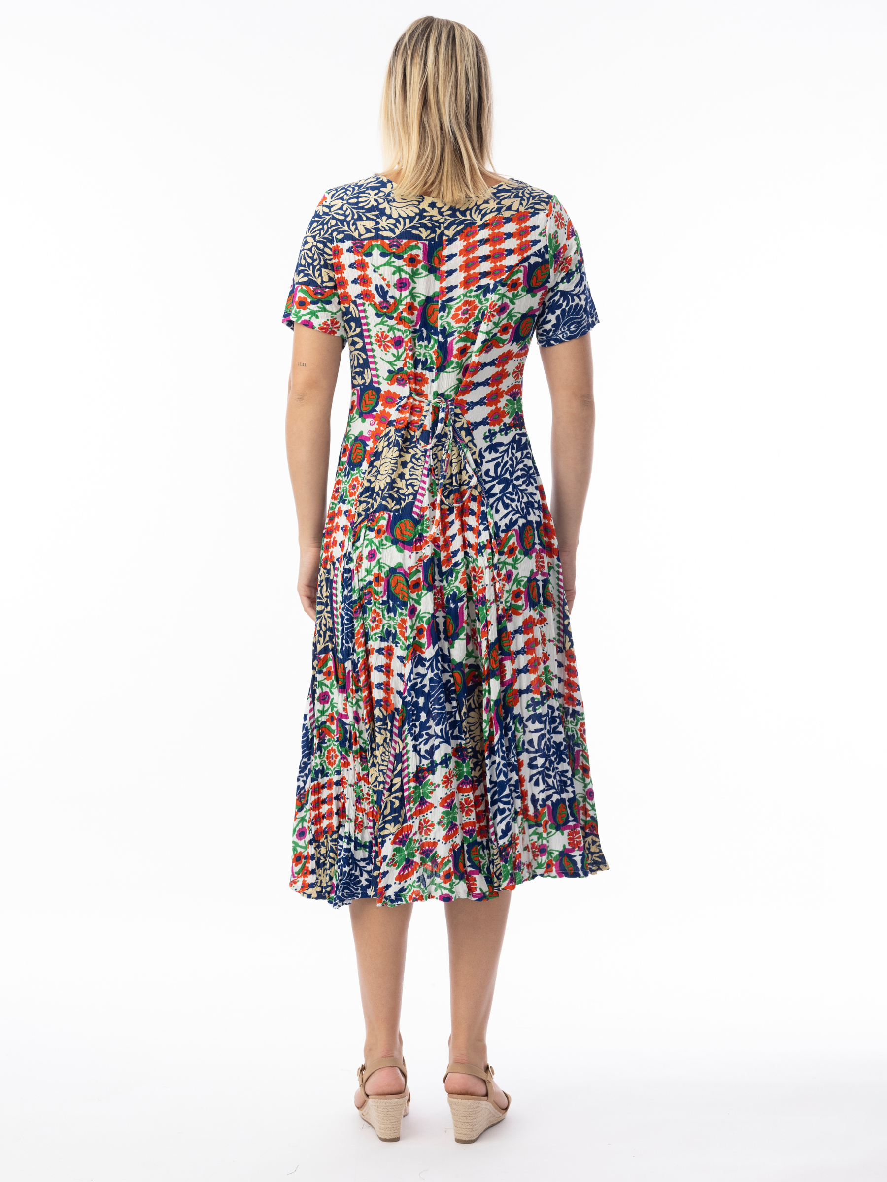 Orientique 30210 Buzios Godet Dress printed midi A-line dress with V-neckline, short sleeves and flared godet skirt.