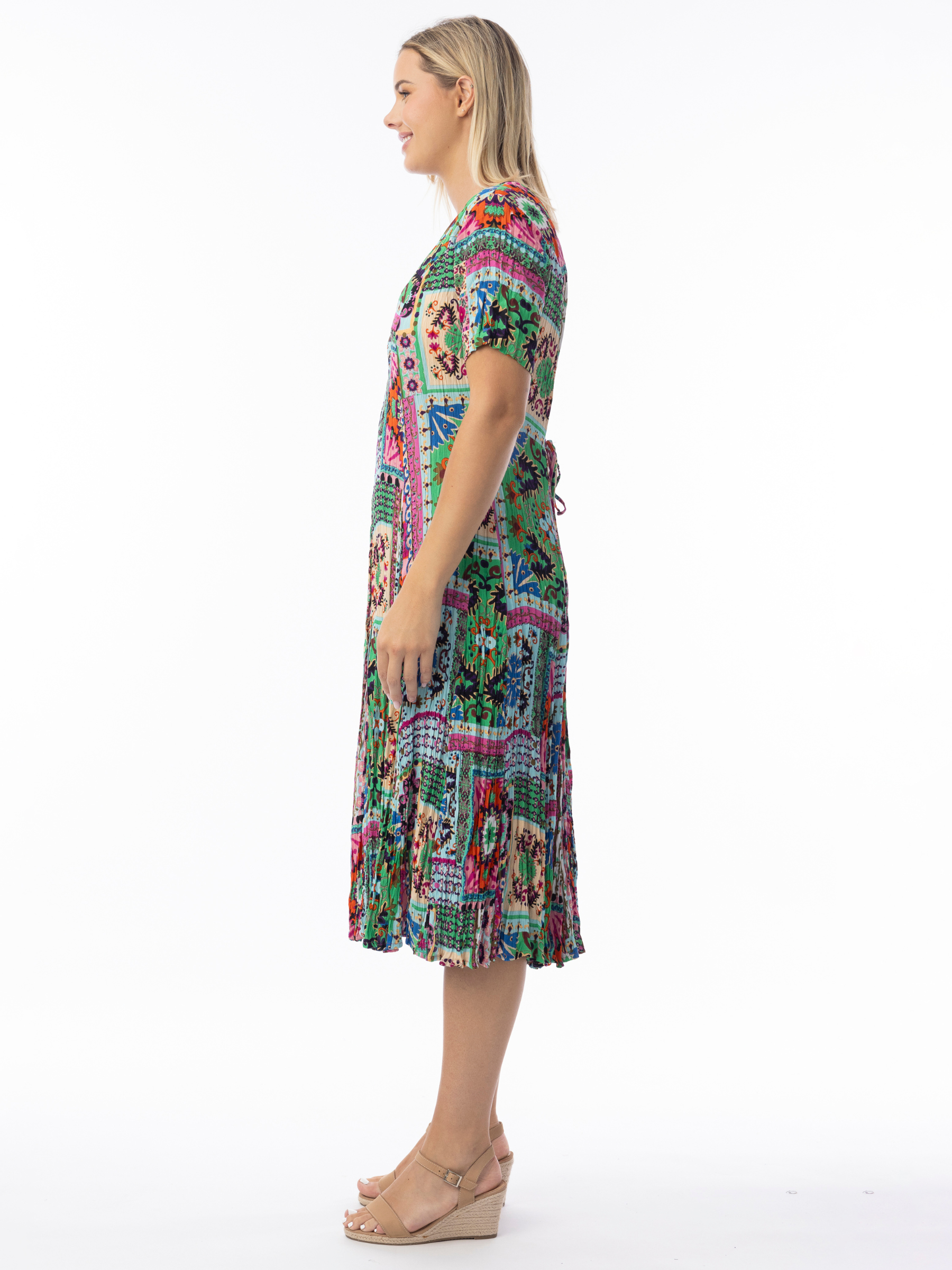 Orientique 61742 Sao Bento Gobet Dress with V-neckline, short flared sleeves and pleated gobet hem in vibrant patchwork-inspired print.