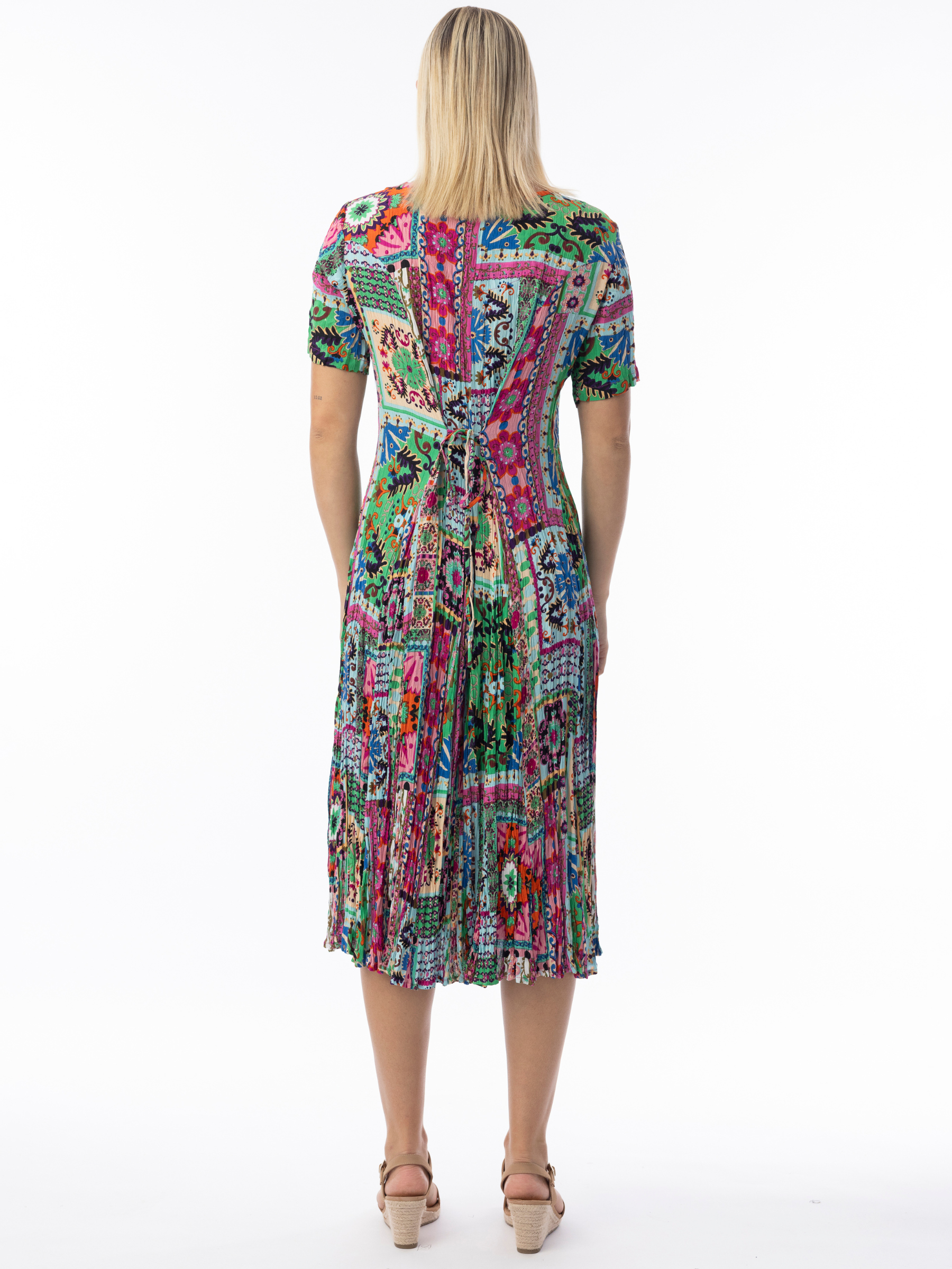 Orientique 61742 Sao Bento Gobet Dress with V-neckline, short flared sleeves and pleated gobet hem in vibrant patchwork-inspired print.