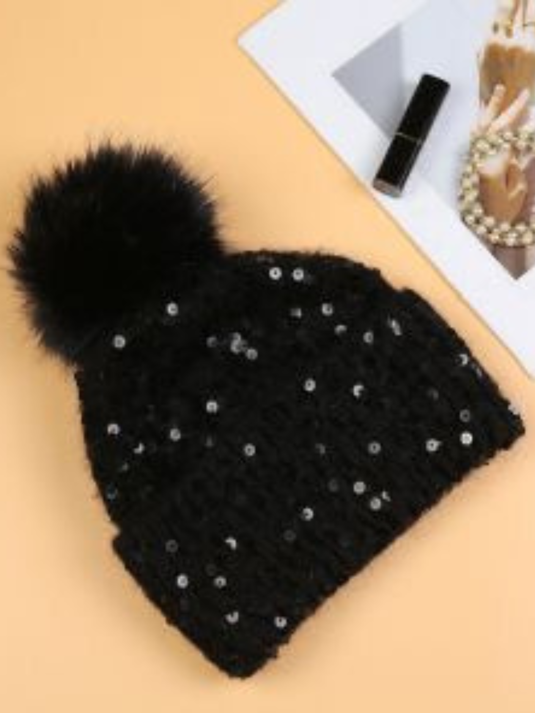 PCHA SD117 Black Sequin Pompom Hat – black knit hat with sequins and faux fur pompom, also available in red and cream. Perfect for chic winter styling.