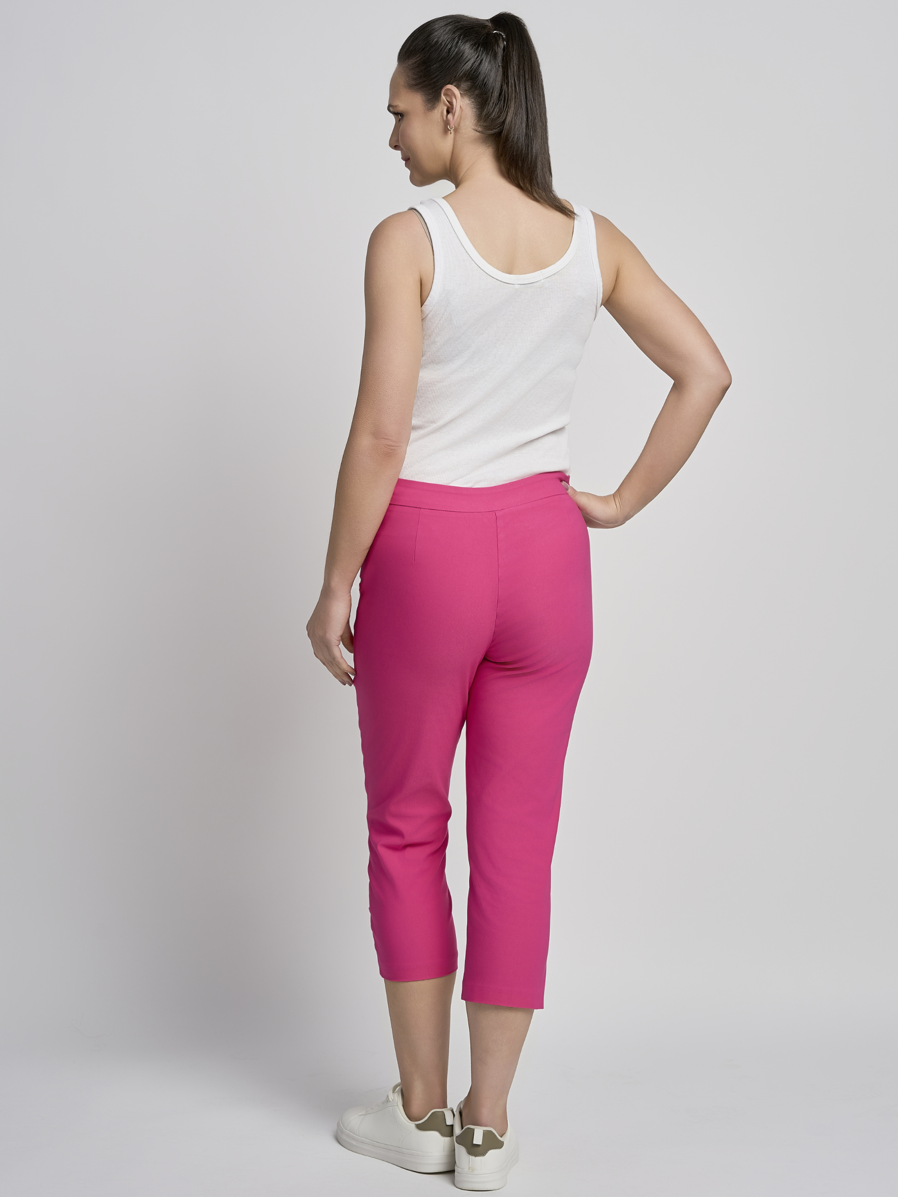 PINNS 408C fuchsia women’s sculpting bengaline crop trousers with hidden tummy control and diamond eyelet hem.