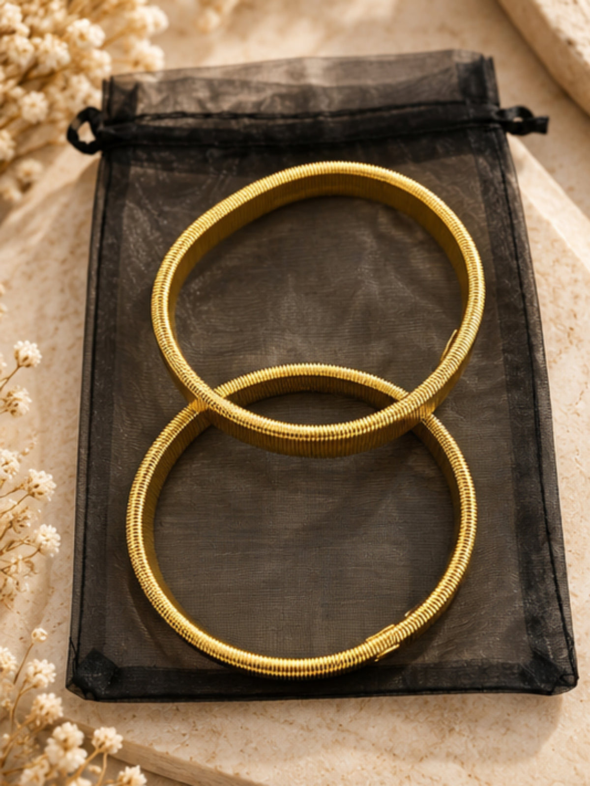QB26 Shirt Sleeve Bracelets with structured circular shape and coiled textured detailing.