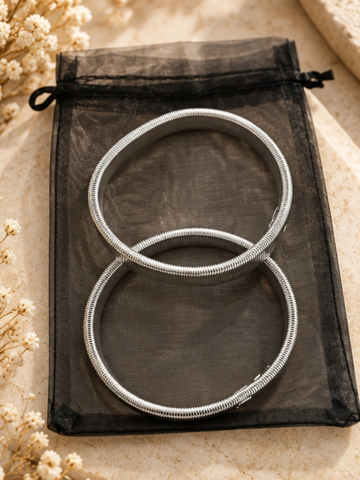 QB26 Shirt Sleeve Bracelets with structured circular shape and coiled textured detailing.