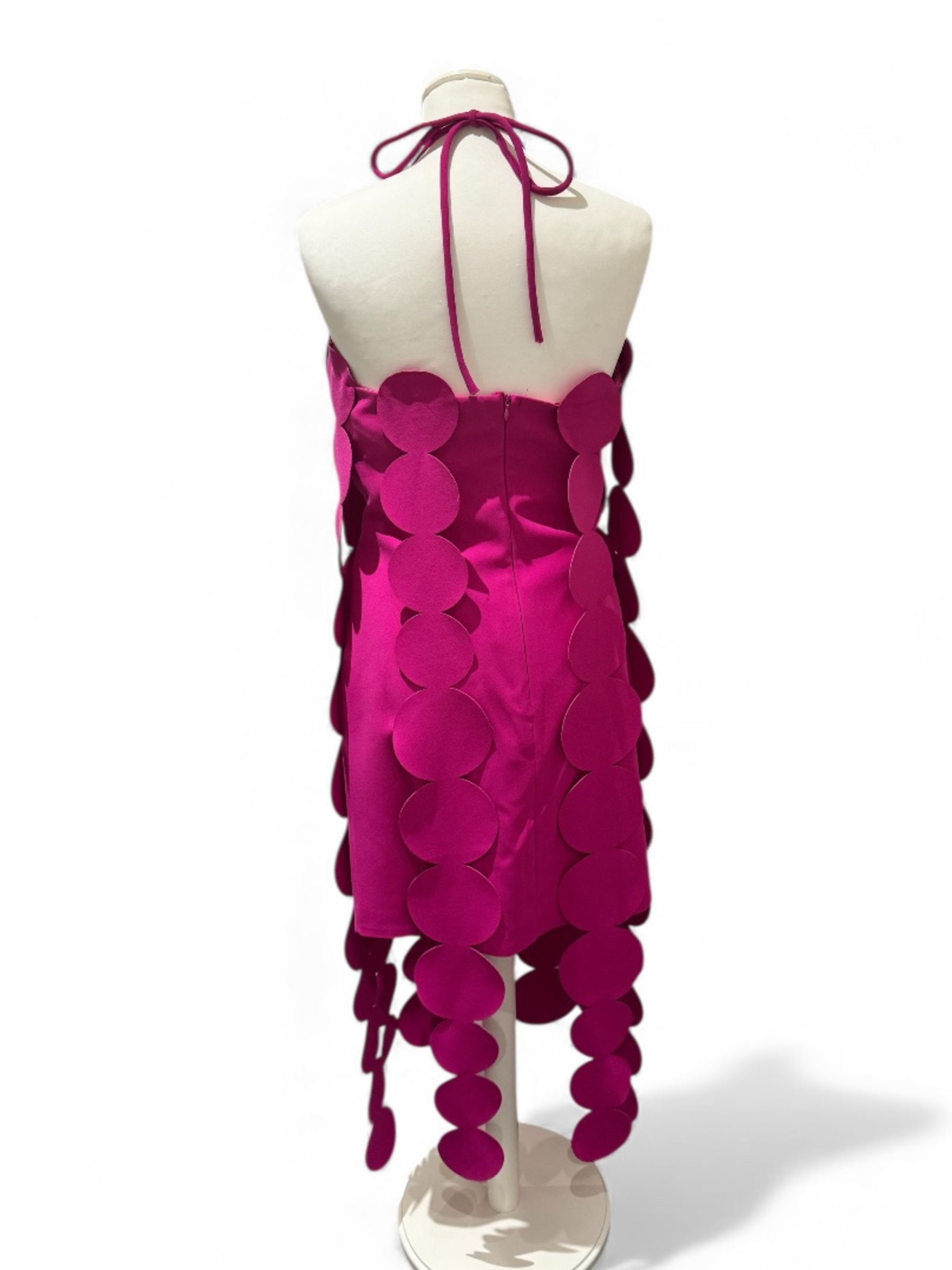 Fuchsia circular appliqué yacht dress with halter neckline, bold statement style for events and parties.