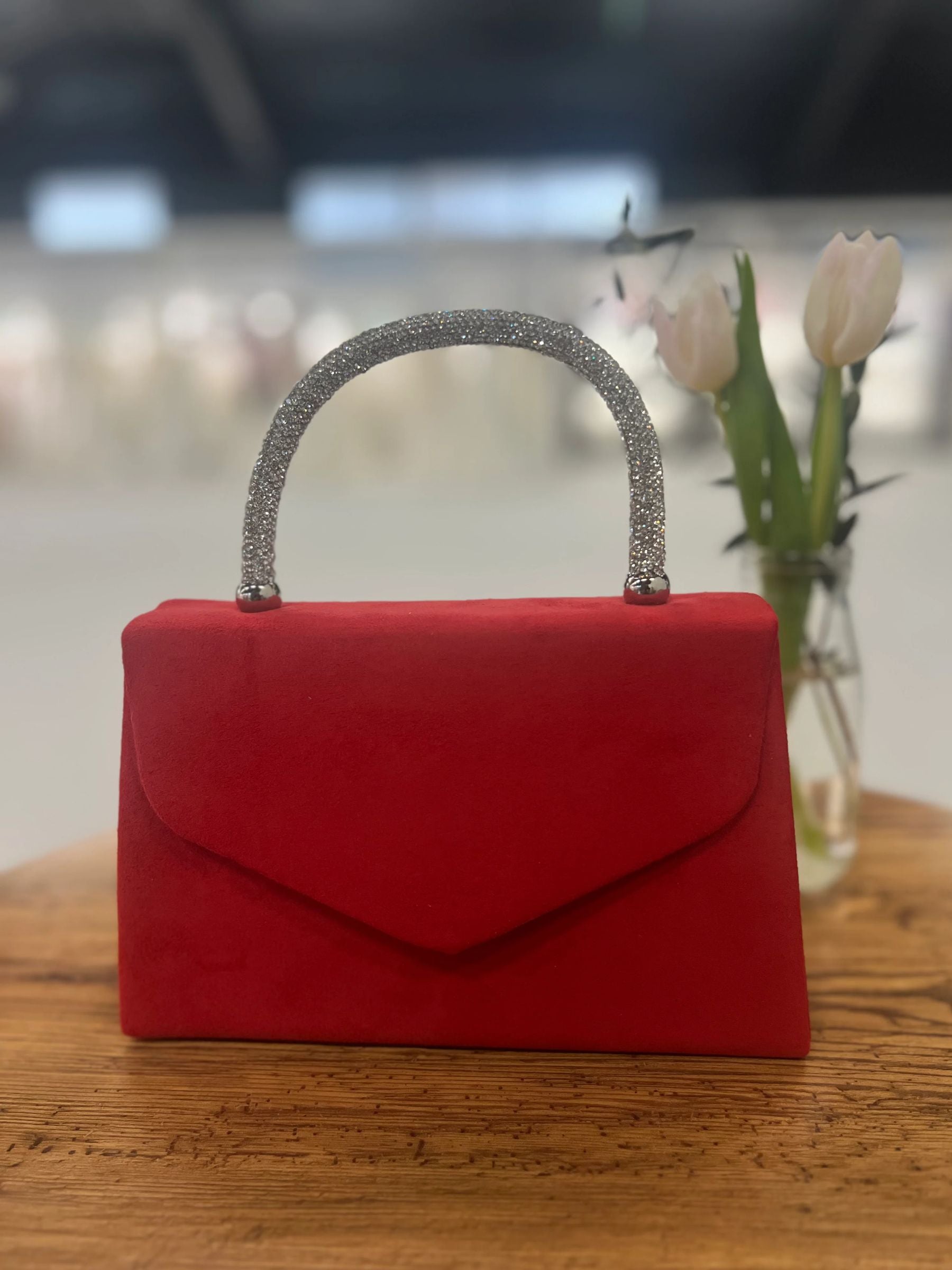 Red structured handbag with sparkling rhinestone handle - elegant women’s evening bag for weddings, parties and chic occasionwear.
