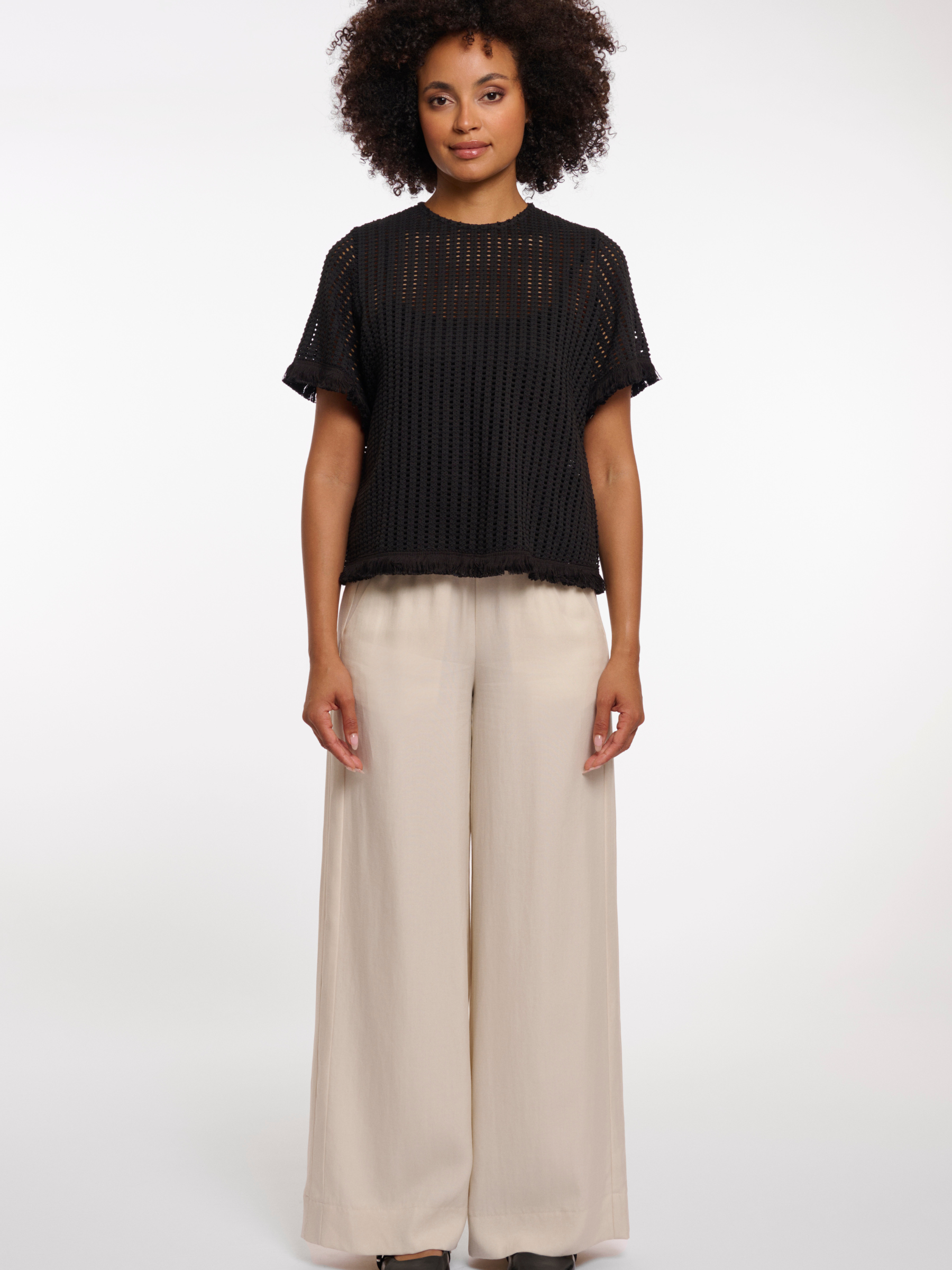 Rino & Pelle Flora Top open knit short sleeve top with fringe trim and round neckline.