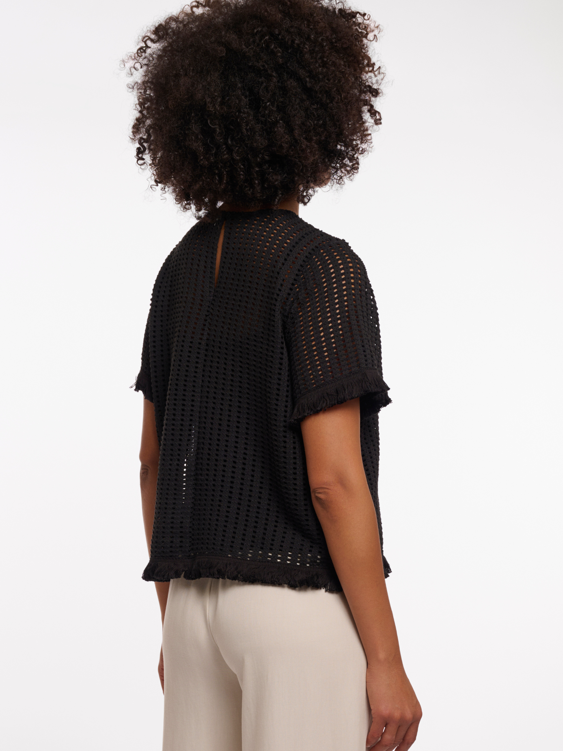 Rino & Pelle Flora Top open knit short sleeve top with fringe trim and round neckline.
