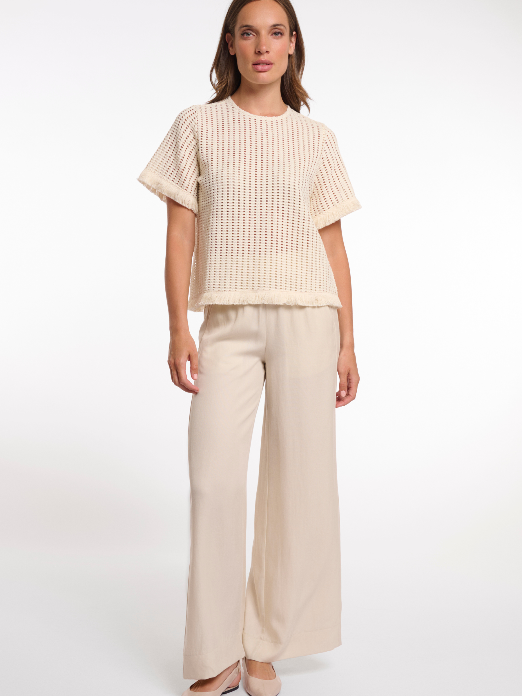 Rino & Pelle Flora Top open knit short sleeve top with fringe trim and round neckline.