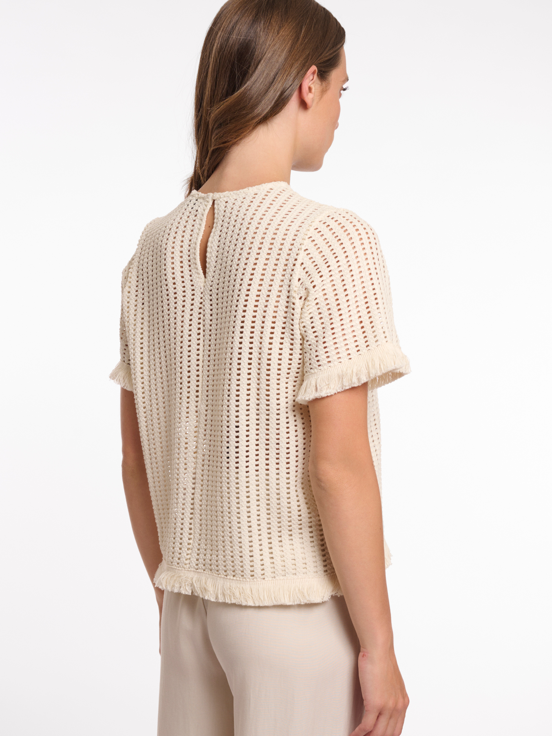 Rino & Pelle Flora Top open knit short sleeve top with fringe trim and round neckline.