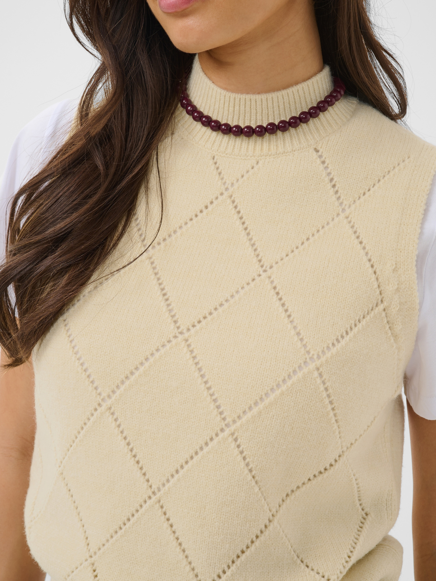 Saint Tropez Theresa Vest with high round neckline, sleeveless shape, diamond stitch detail and ribbed trims