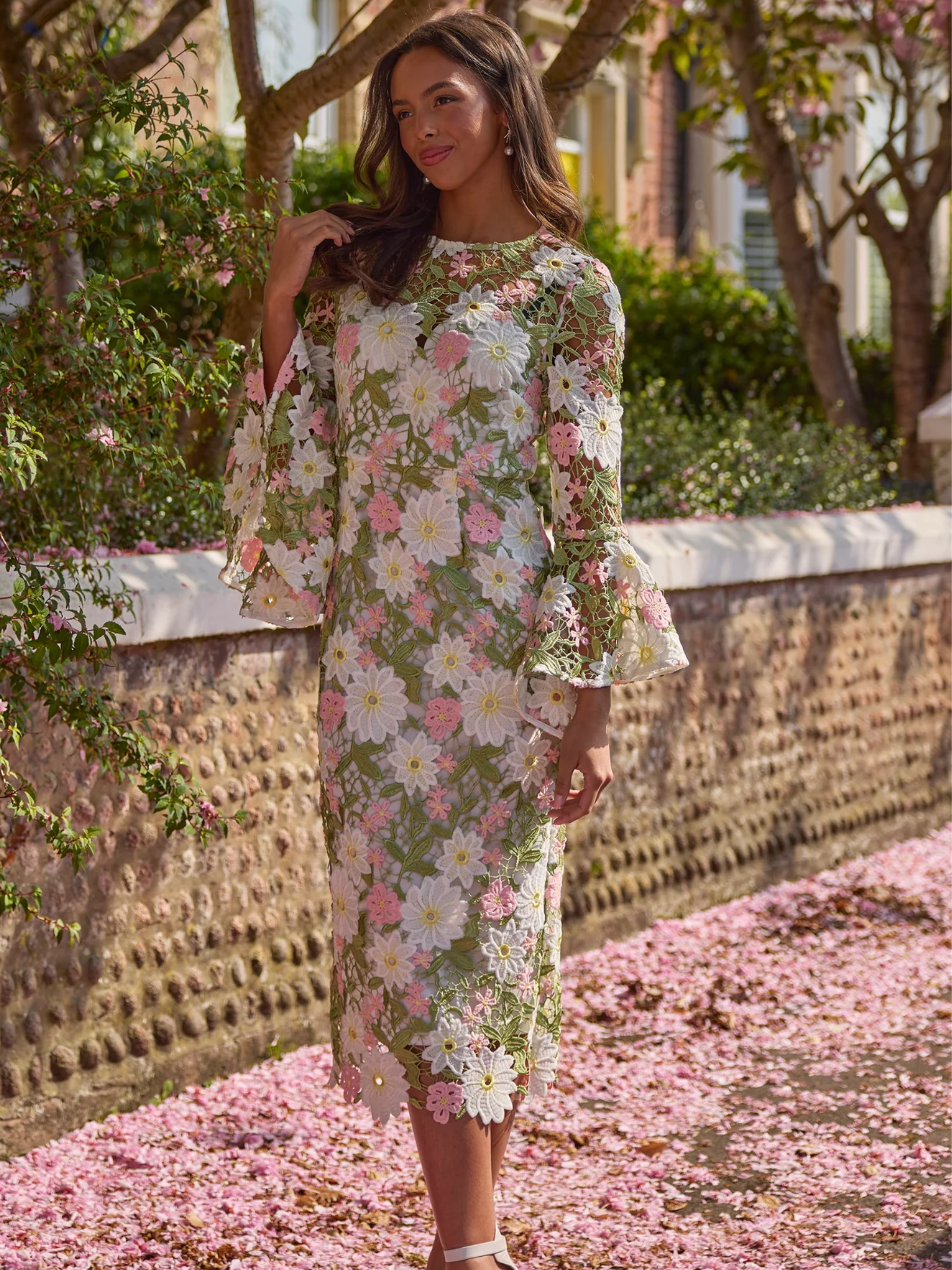 The 8th Sign 8SS605 pink rosaline lace midi dress with floral lace detailing and flared sheer sleeves.