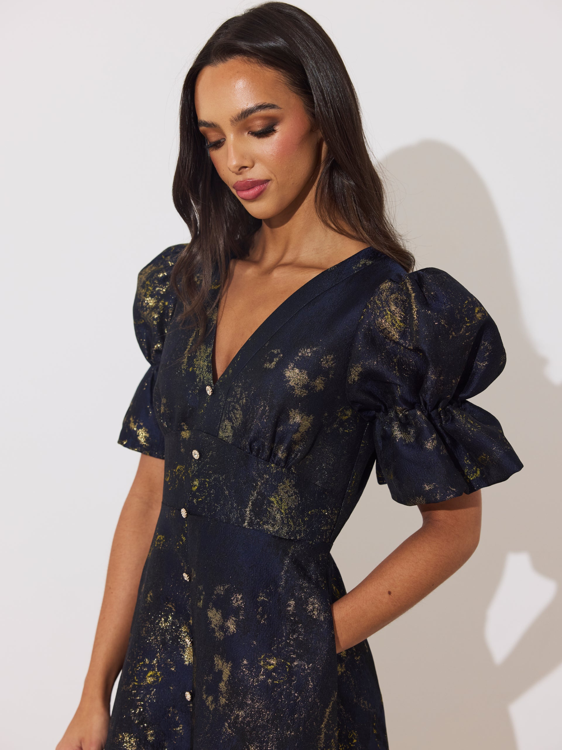 The 8th Sign Callie Metallic Skater Dress with V-neckline, puff sleeves, button-front detail and flared skirt.