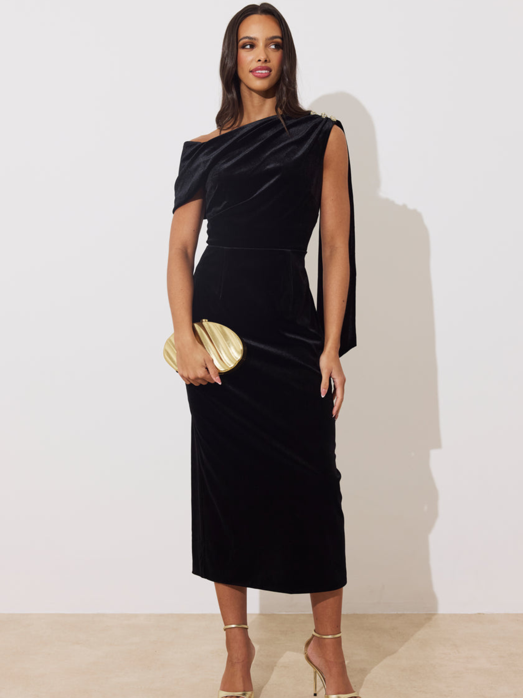 The 8th Sign Eleni Velvet Drape Midi Dress with asymmetric draped neckline, embellished shoulder detail and flowing back drape.