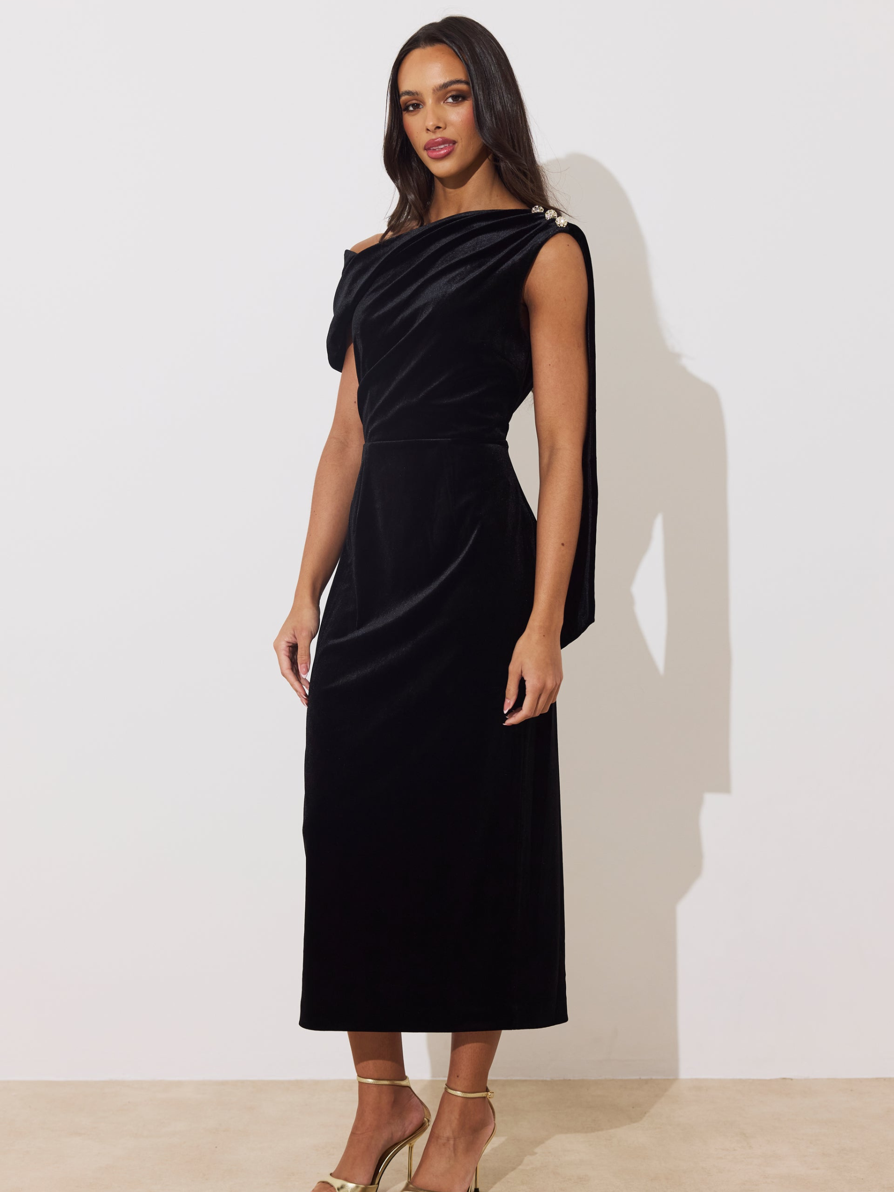 The 8th Sign Eleni Velvet Drape Midi Dress with asymmetric draped neckline, embellished shoulder detail and flowing back drape.