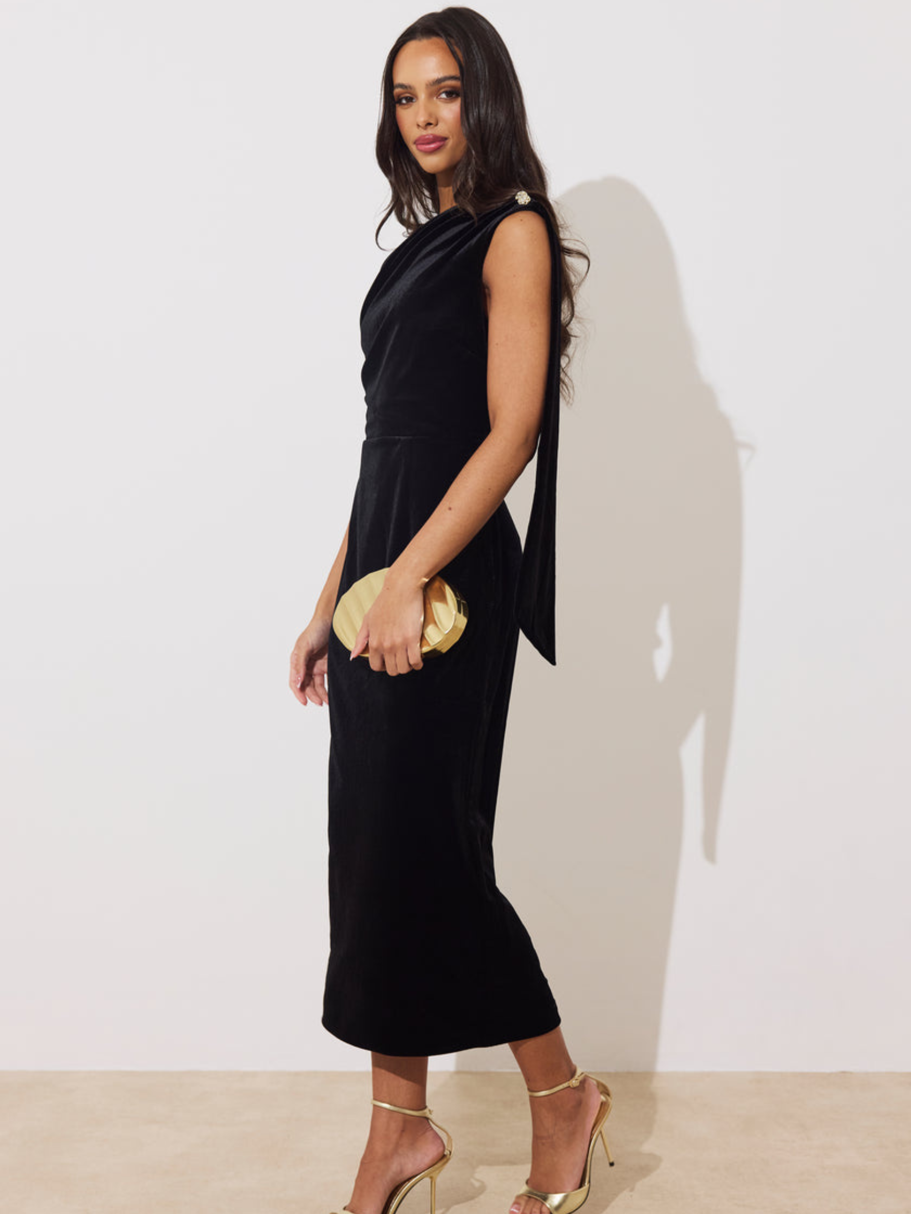 The 8th Sign Eleni Velvet Drape Midi Dress with asymmetric draped neckline, embellished shoulder detail and flowing back drape.