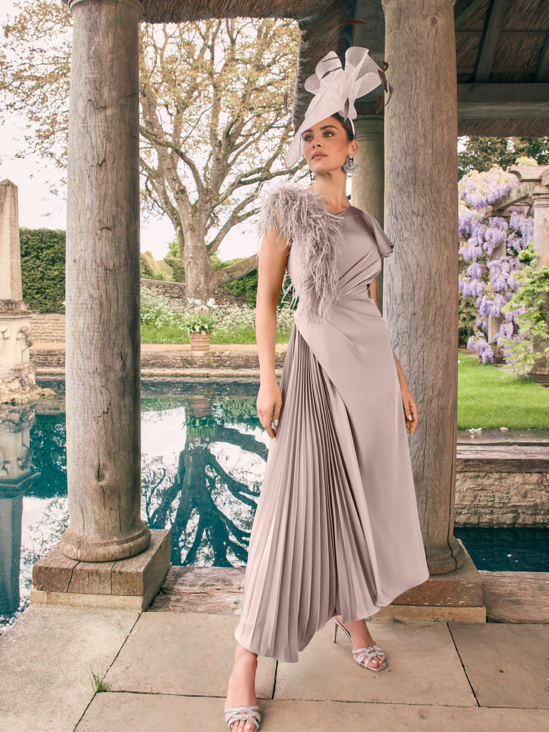 Veni Infantino 992756 Taupe Dress – modern taupe crepe dress with feather strap detail, half-pleated skirt and asymmetrical high-low design, perfect for elegant weddings and race-day events.