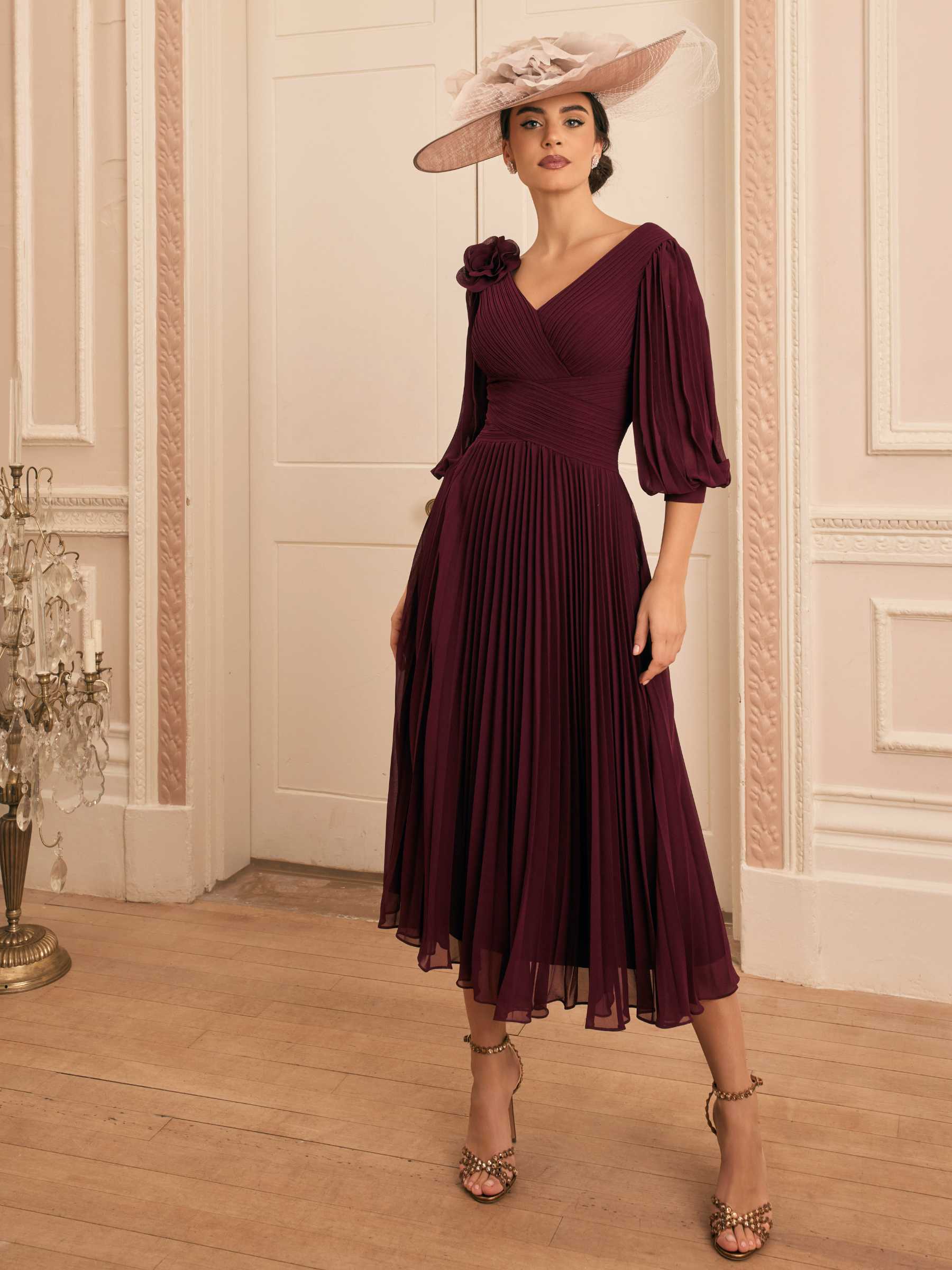 Veni Infantino 992822 Wine Dress with V-neckline, bishop sleeves, floral shoulder detail and pleated A-line skirt