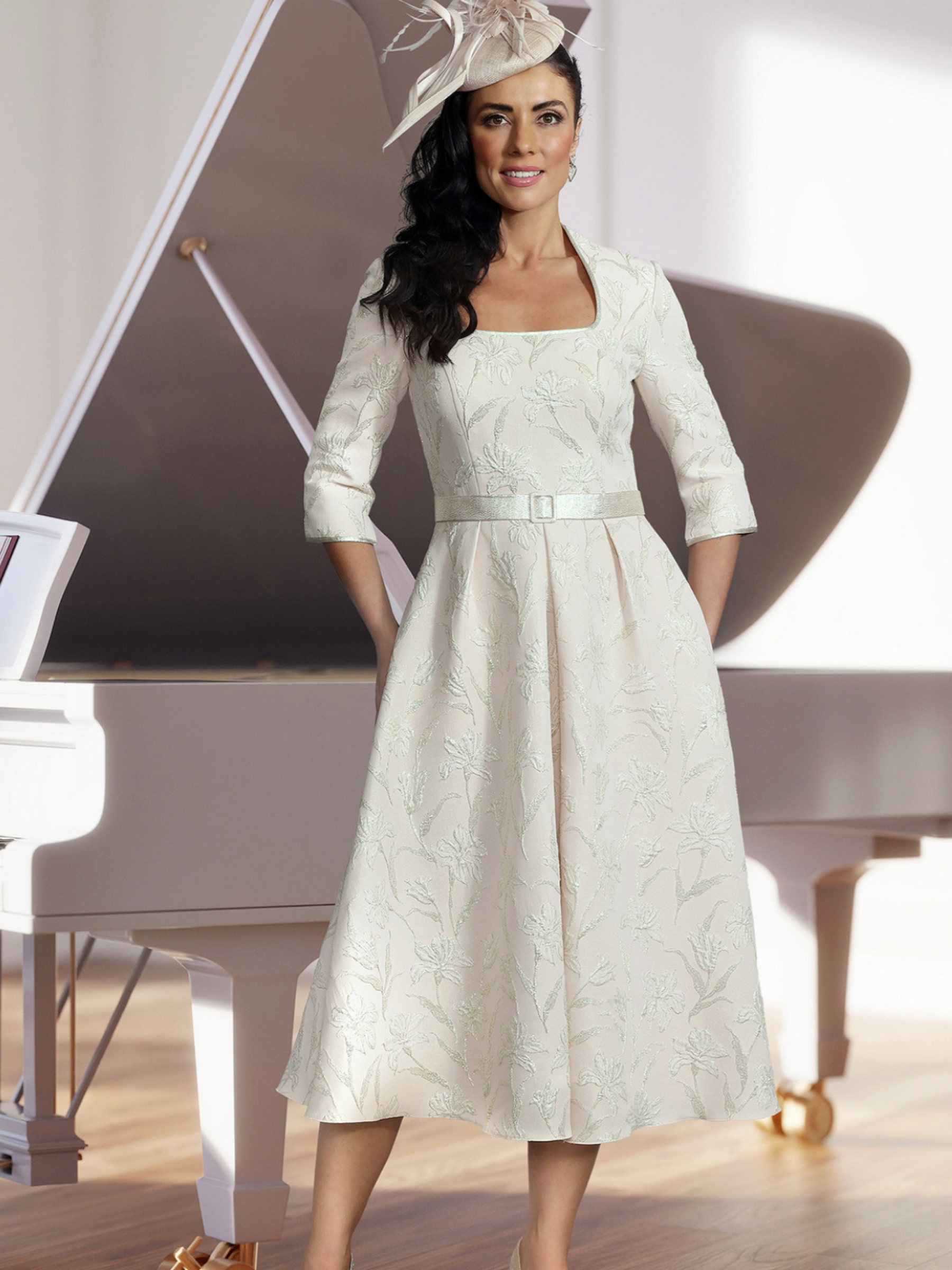 Veromia Occasions VO2922 shell pink dress with square neckline, three-quarter sleeves, belted waist and A-line skirt.