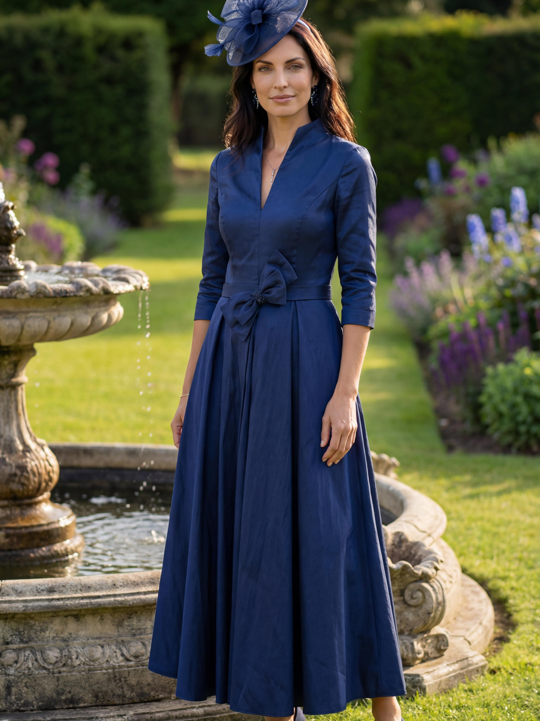 Veromia Occasions VO3147 Navy Dress A-line occasion dress with V-neckline, stand collar and waist tie detail