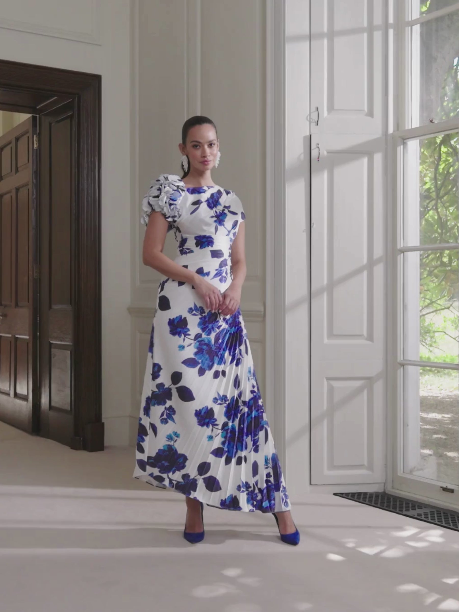 John Charles 66775 Blue Carnation Dress with floral print, asymmetric plissé midi skirt and floral cutwork sleeve.