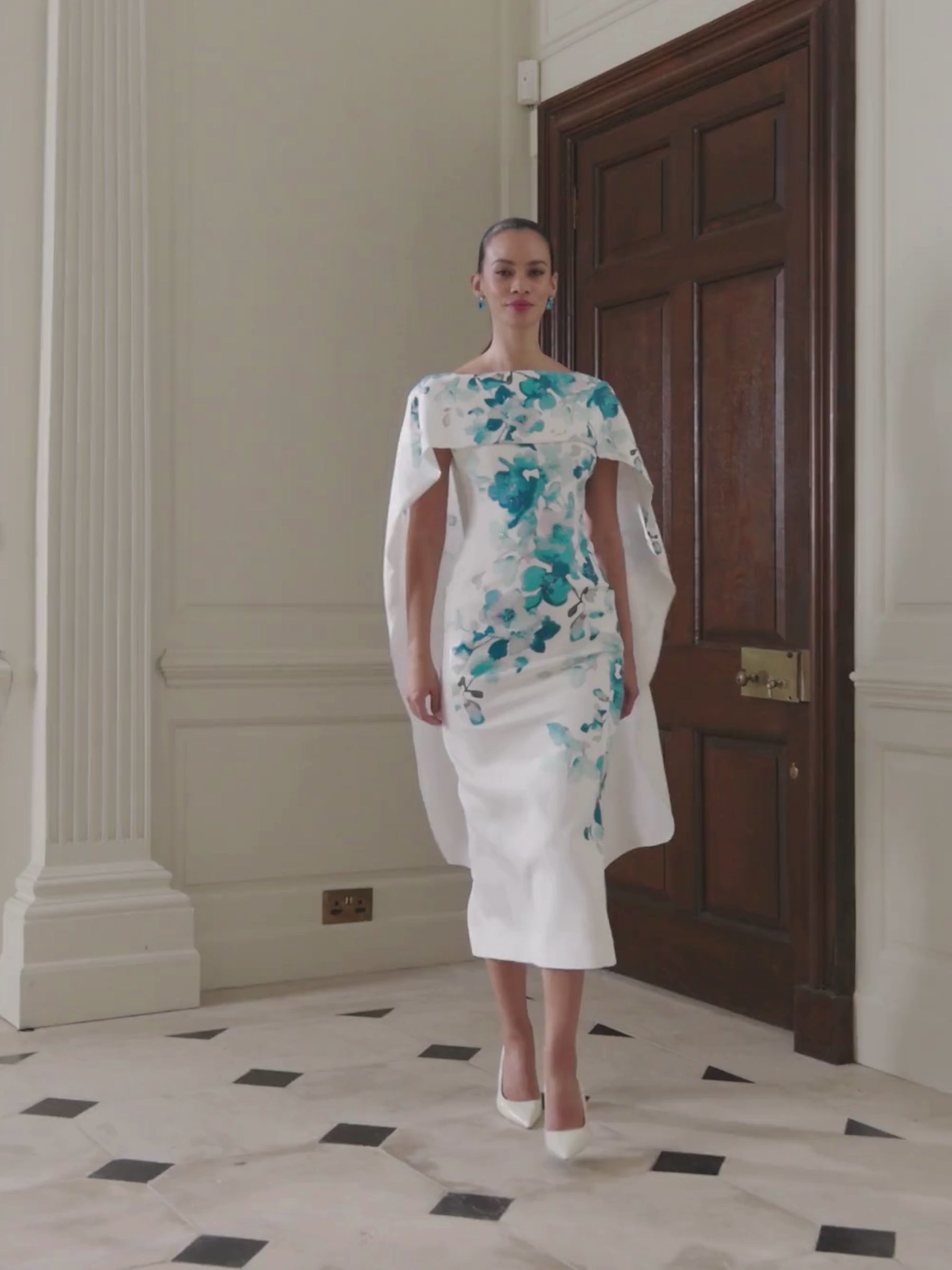 John Charles 66698 Teal Dress featuring a teal floral print, cape-style shoulder overlay and a sleek fitted silhouette — a sophisticated occasion dress perfect for weddings and elegant events.