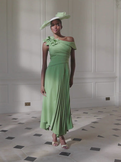 John Charles 66755A Fern Dress with asymmetric neckline, pleated bodice, A-line pleated skirt and floral cutwork shoulder detail.