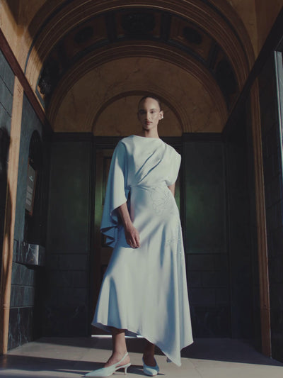 Maisonel ME3109 Sky Dress - elegant A-line midi dress in soft sky blue with asymmetric cape sleeve and flowing crepe fabric, perfect for weddings and formal occasions.