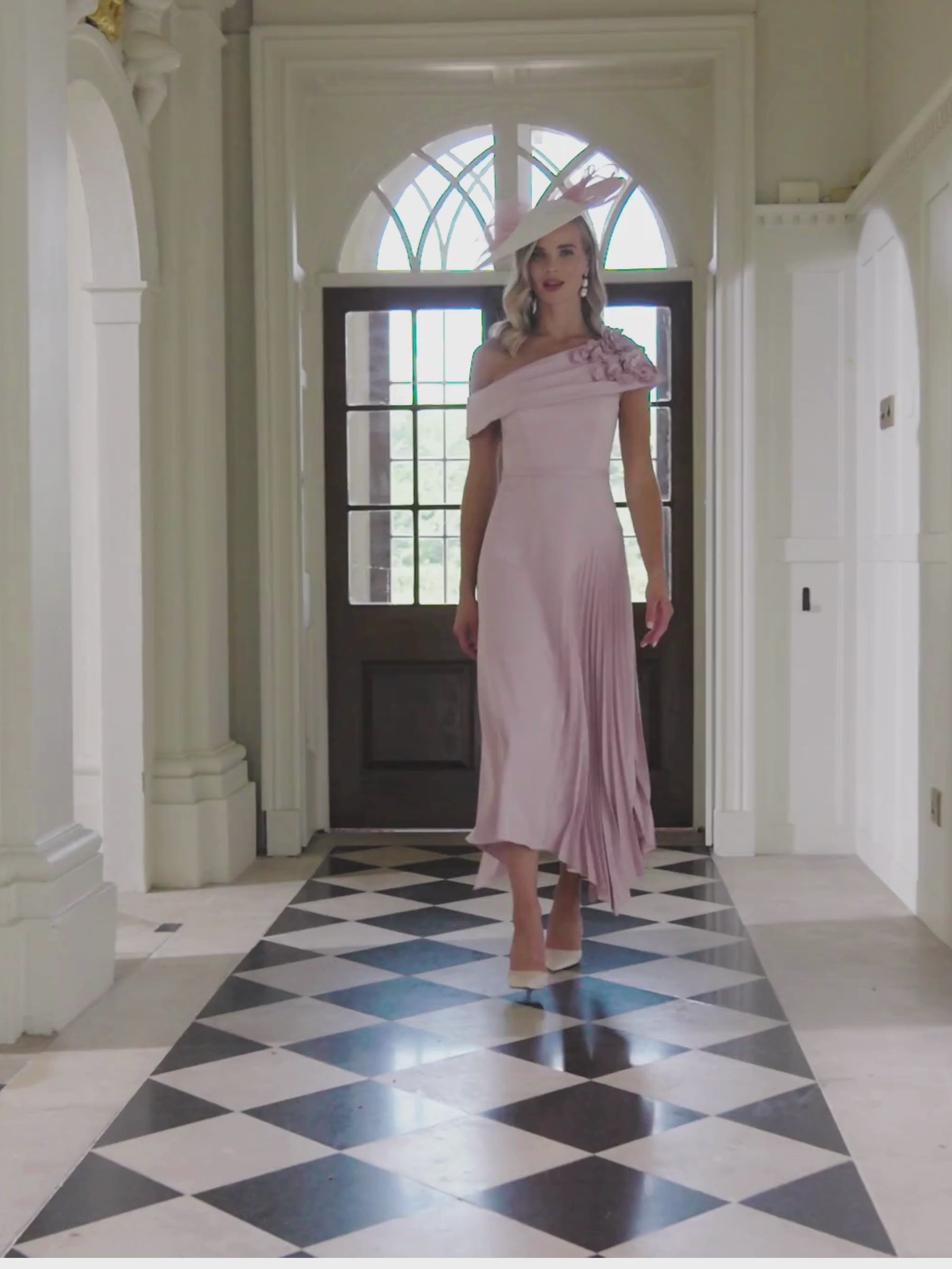 John Charles 29362A Petal Dress with one-shoulder neckline, 3D floral appliqués and pleated asymmetric midi skirt – a romantic petal-pink occasion dress ideal for weddings and elegant events.