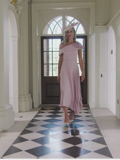 John Charles 29362A Petal Dress with one-shoulder neckline, 3D floral appliqués and pleated asymmetric midi skirt – a romantic petal-pink occasion dress ideal for weddings and elegant events.