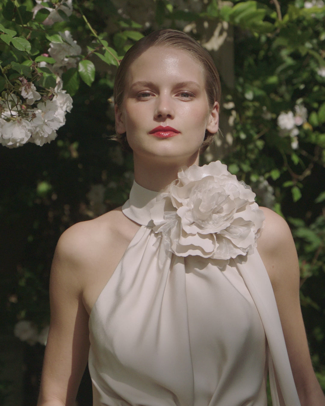 Maisonel ME3004 Oyster Dress – women’s halter neck satin occasion dress in elegant oyster tone with floral applique and asymmetric hem, perfect for weddings and formal events.