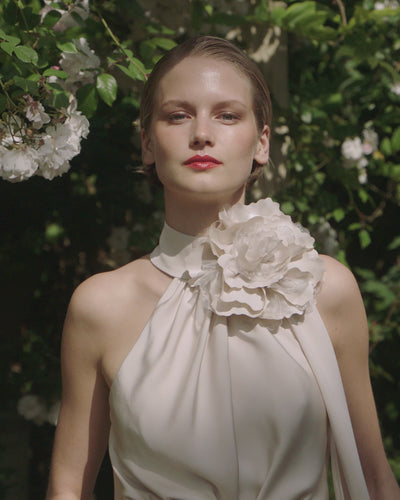 Maisonel ME3004 Oyster Dress – women’s halter neck satin occasion dress in elegant oyster tone with floral applique and asymmetric hem, perfect for weddings and formal events.