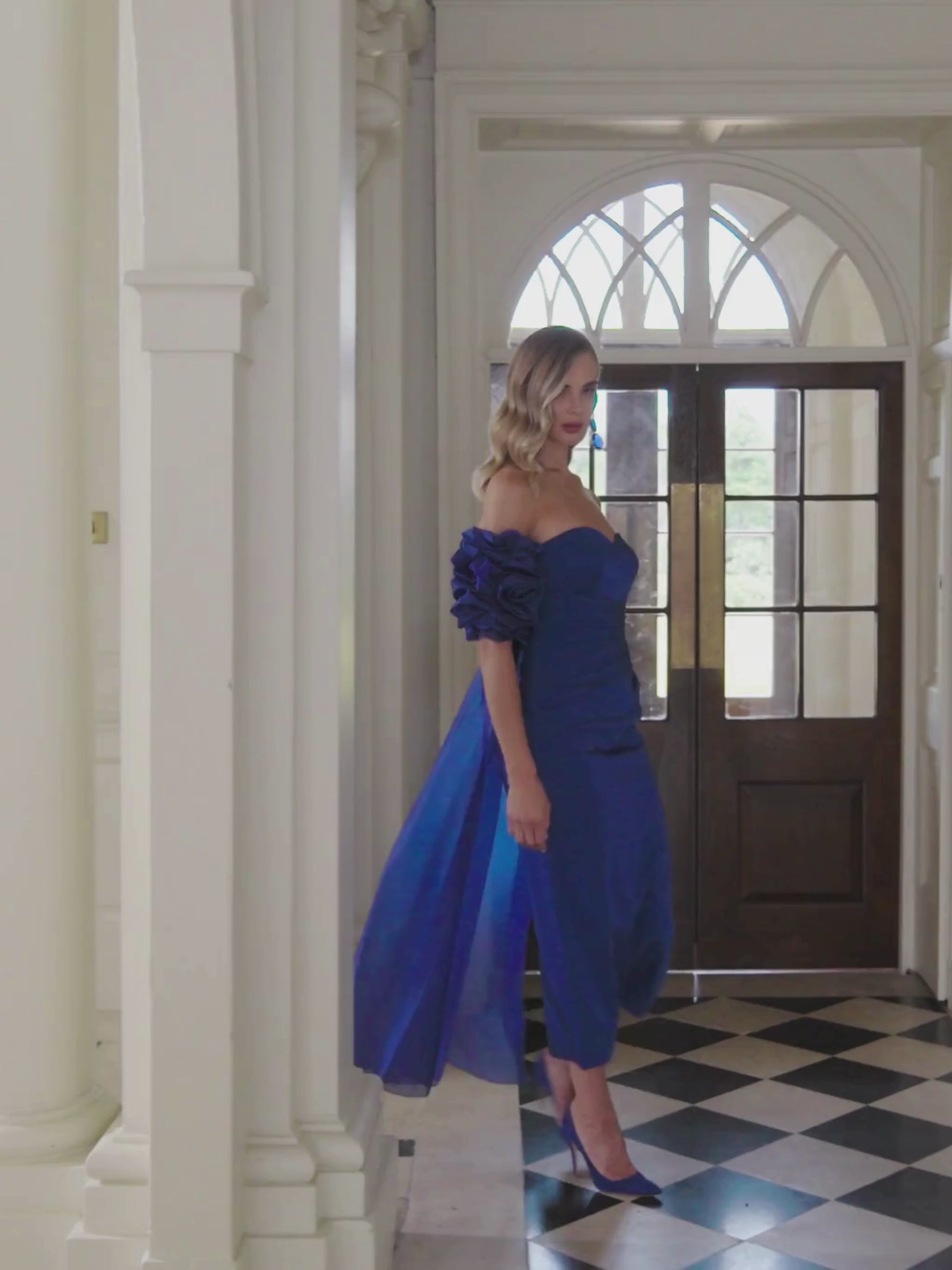 John Charles 29356 Sapphire Dress with strapless neckline, fitted crepe silhouette, organza floral sleeves and dramatic organza cape.