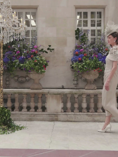 John Charles 29337A Oyster Dress with asymmetric bardot collar, sparkle stretch fabric, straight midi skirt and floral shoulder detailing.