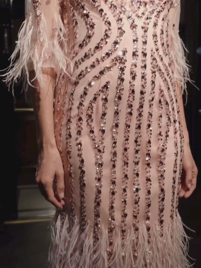 Gill Harvey Bernadette Rose Dress featuring sequin embellishment, feather-trimmed sleeves and hemline and a classic boat neckline - a stunning Mother of the Bride or special occasion dress.